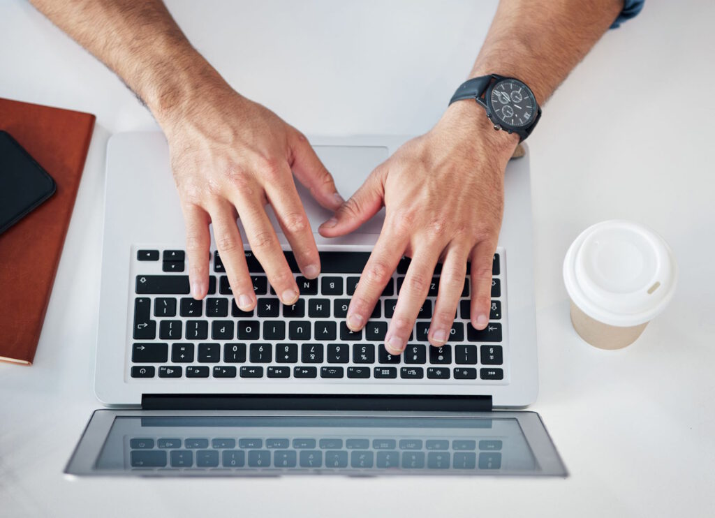 Hands on a laptop
